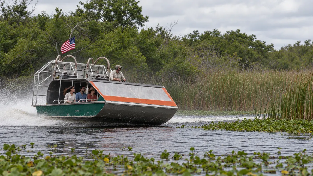 Airboat carrying guests through the grassy Everglades waterway